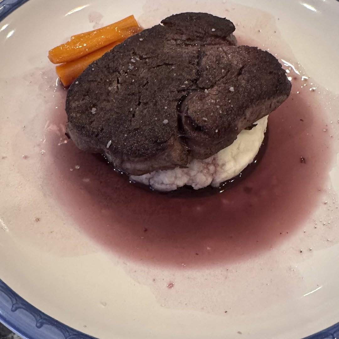 Filet mignon over whipped potato with red wine reduction